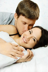 Obraz na płótnie Canvas happy couple in bed