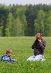 young pregnant photographer woman with her son