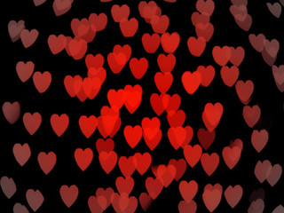 Soft focus red hearts on a black background