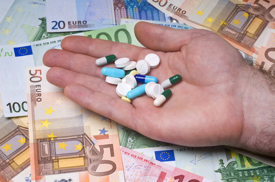 Health-human hand with pill over euro money
