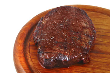grilled beef on wooden plate