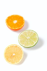 Fototapeta na wymiar a group of three halves of a tangerine, a lemon and a lime