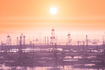 Oil derricks on early morning - Caspian see near Baku