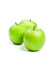 three fresh green granny smith apples isolated on white