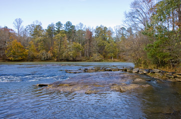 Blue River Along Autumn Trees