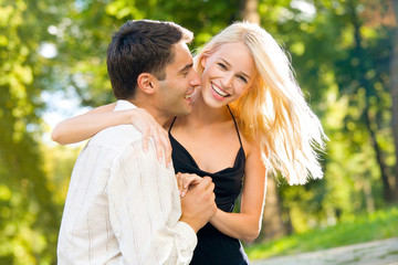 Young happy smiling couple walking outdoors together