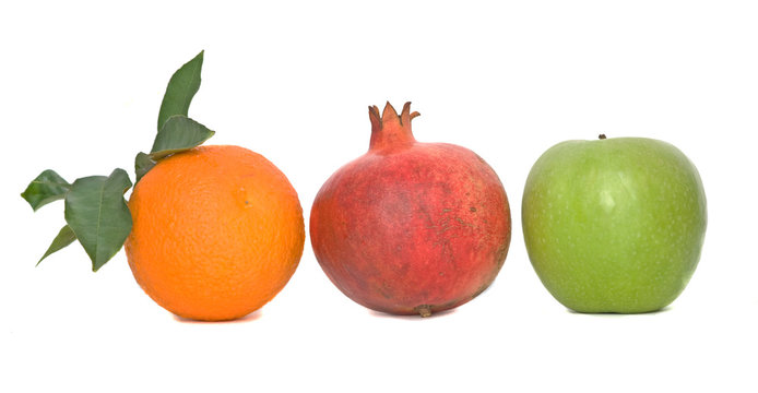 Pomegranate, orange, and apple isolated on white background