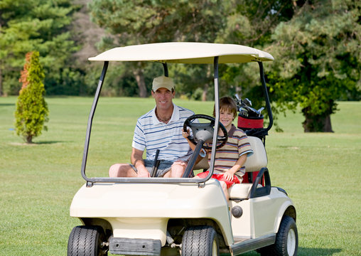 Father and Son in Golf Cart