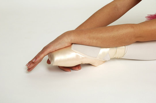 close up shot of foot and arm of ballerina