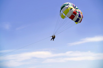 an image of two men parasailing in the sky