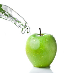 fresh water splash on green apple isolated on white