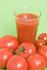 Fresh tomatoes and a glass full of tomato juice