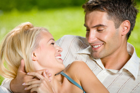 Portrait of young happy attractive couple together, outdoors