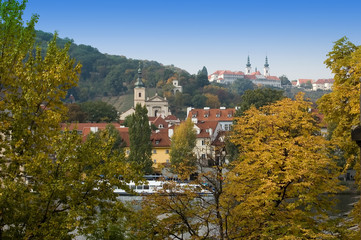 View  on autumn Prague through foliage