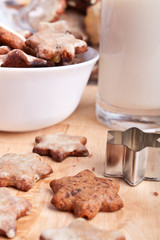 christmas cookies on a wooden board and a glass of milk