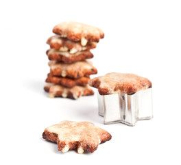 a stack of star-shaped christmas cookies with a cookie-form