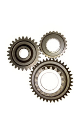 Three cog gears meshing together over white