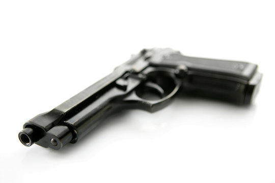 black hand gun pistol over white background