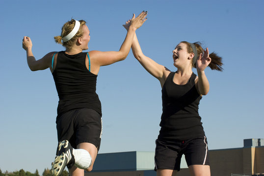 Soccer Girls celebrate with a high five