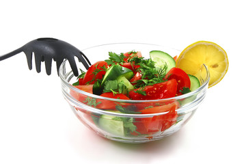 fresh raw vegetable salad in transparent bowl