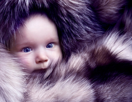 Baby in fur coat