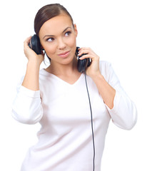 Beautiful young lady with music headphones on white