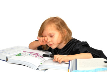 Naklejka premium Cute little girl is waking up after reading lots of textbooks