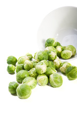 Brussels sprouts and plate on white background