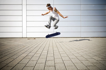 skater making a flip with his skateboard © sint
