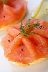Smoked salmon on bagel with fresh black pepper.