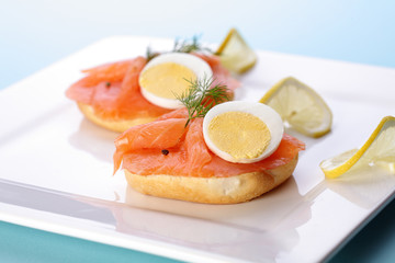 Smoked salmon on bagel with fresh black pepper.