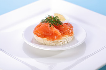 Smoke salmon on bagel with freshly black pepper.
