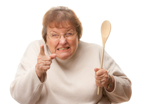 Unhappy Senior Woman with The Wooden Spoon