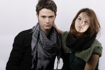 young attractive couple looking at camera hugging