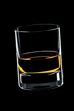 glass of whiskey isolated over black background