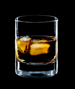 glass of whiskey and ice isolated over black background