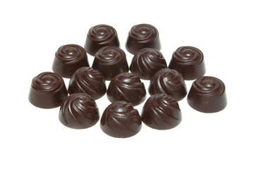 Delicious dark chocolate pralines isolated on white.