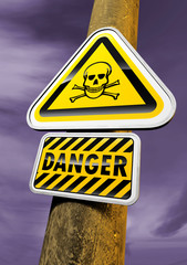 Danger skull sign against the purple sky