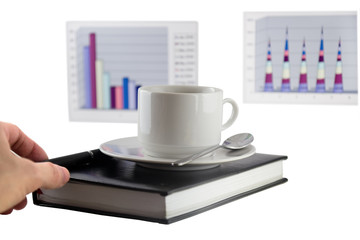 Coffee, standing on organizer, and  diagrams .Focus at the pen