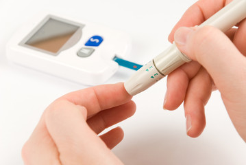 Woman with diabetes measuring blood sugar level