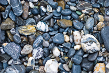blue, grey, brown and white pebbles close up