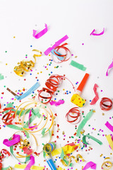 confetti and colorful blowers on white background