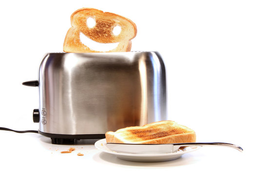 Toasted bread with toaster on white