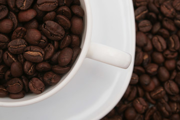 Coffee cup with coffee beans.Closeup.
