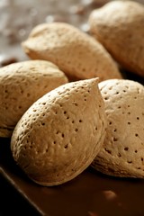 Almond nuts over chocolate, delicious golden food