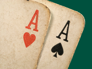 2 old dirty aces poker cards close up.