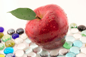 Fototapeta na wymiar apple with drops in the glass stones