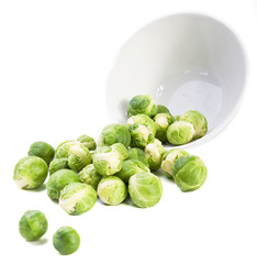 Brussels sprouts and plate on white background
