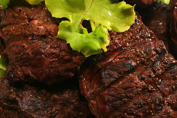 juicy beef meat and green salad over white