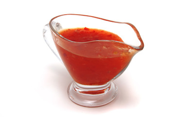 thai sauce inside transparent vase over white